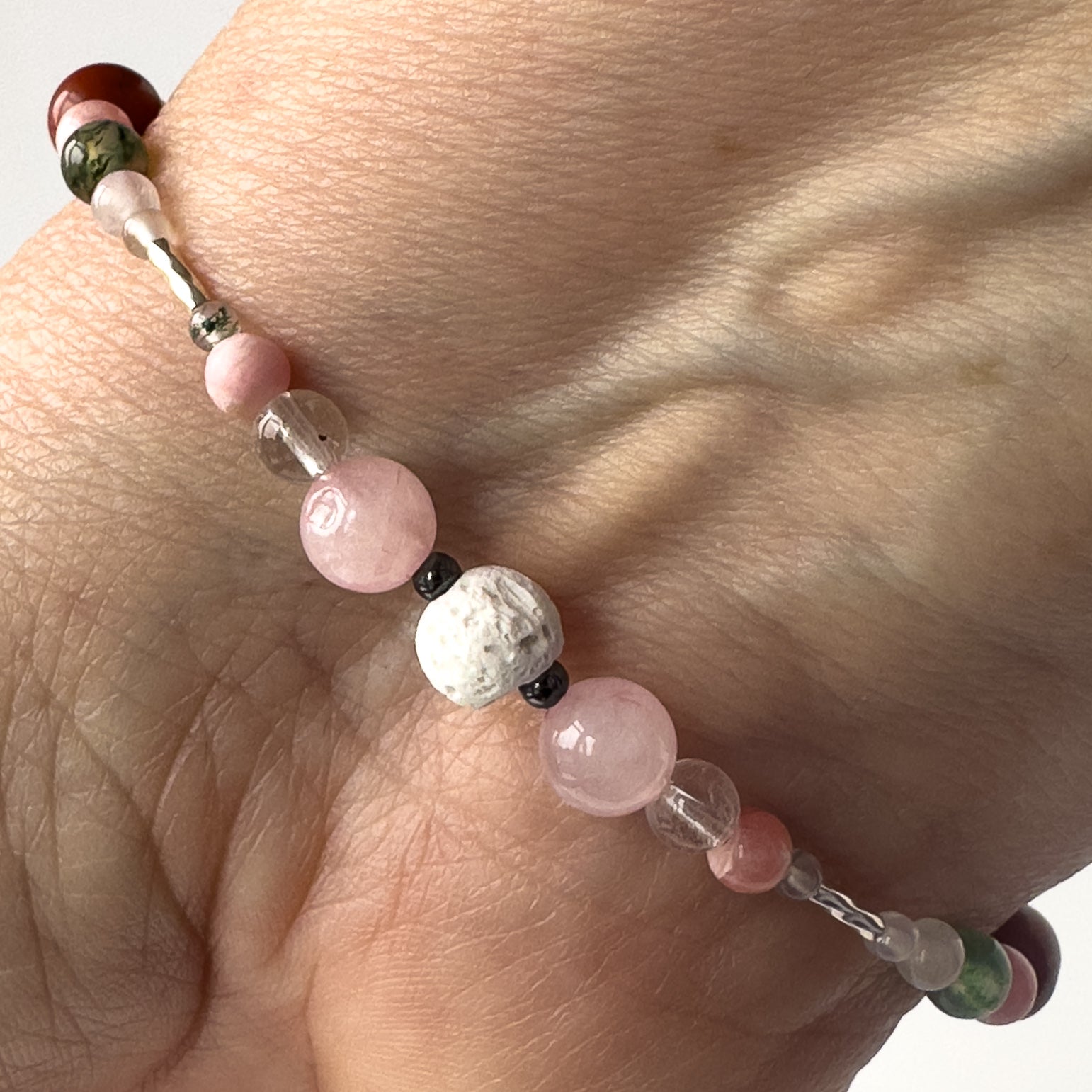Aquarius Birthstone Healing Crystal bracelet for Love and Compassion Close-up showing Rose Quartz, Hematite, Moss Agate, Rhodochrosite, Lava Stone and Clear Quartz