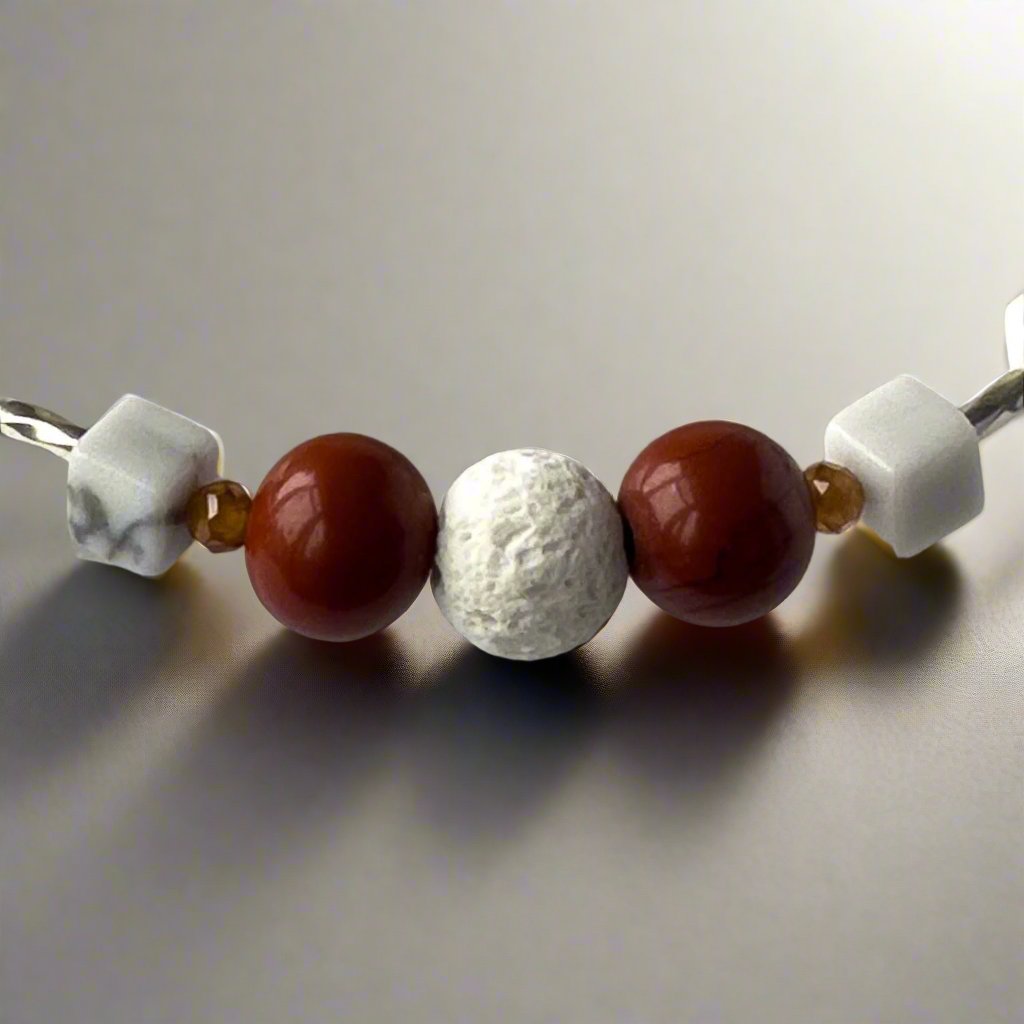 Aries Birthstone Healing Crystal bracelet for Love and Compassion showing Garnet, Howlite, Red Jasper and Lava Stone