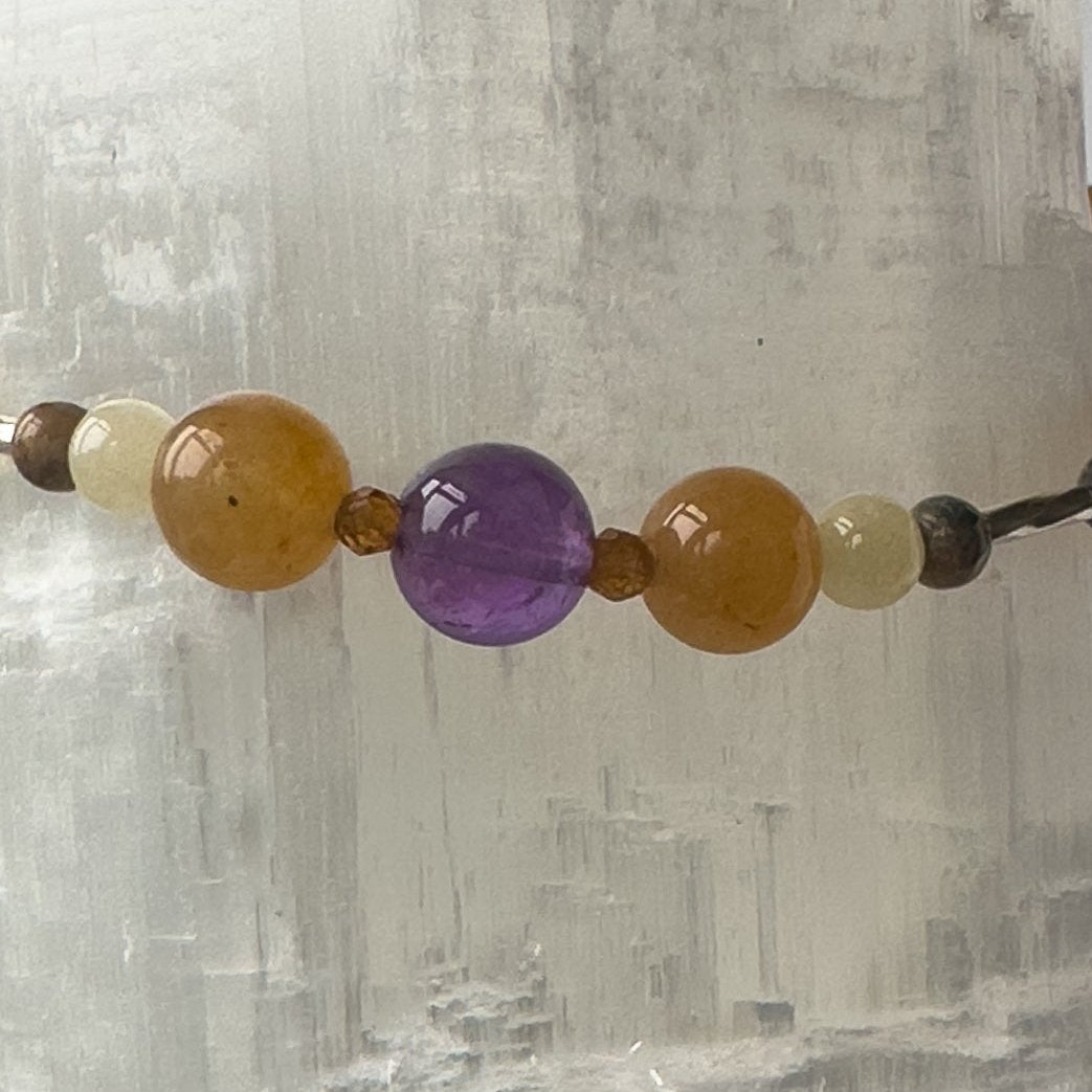 Aries Birthstone Healing Crystal bracelet for Determination & Willpower Close-up of Amethyst, Leopardskin Jasper, Aragonite, Garnet and Carnelian