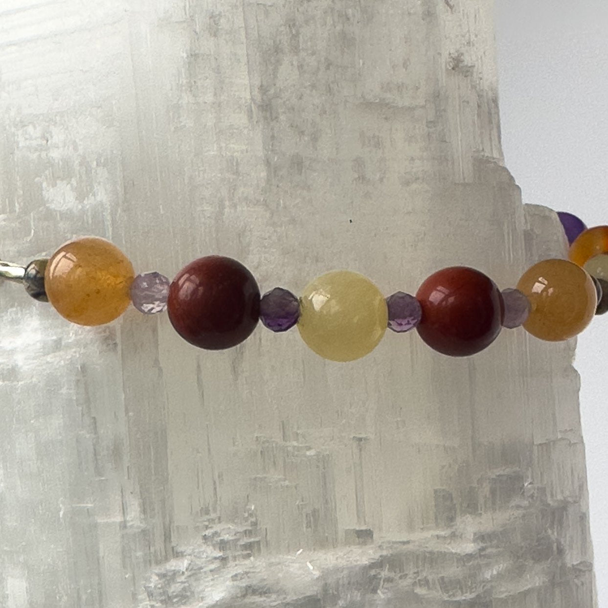Aries Birthstone Healing Crystal bracelet for Determination & Willpower Close-up of Amethyst, Red Jasper, Leopardskin Jasper, Aragonite and Carnelian