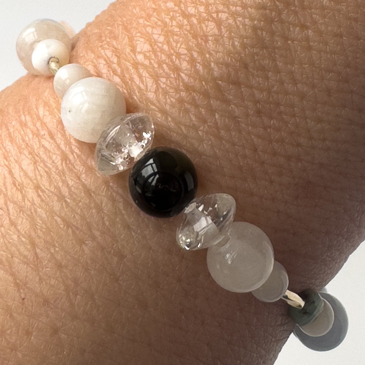 Cancer birthstone Healing Crystal bracelet for Calm & Stress relief on wrist showing Moonstone, Obsidian, Selenite and Clear Quartz