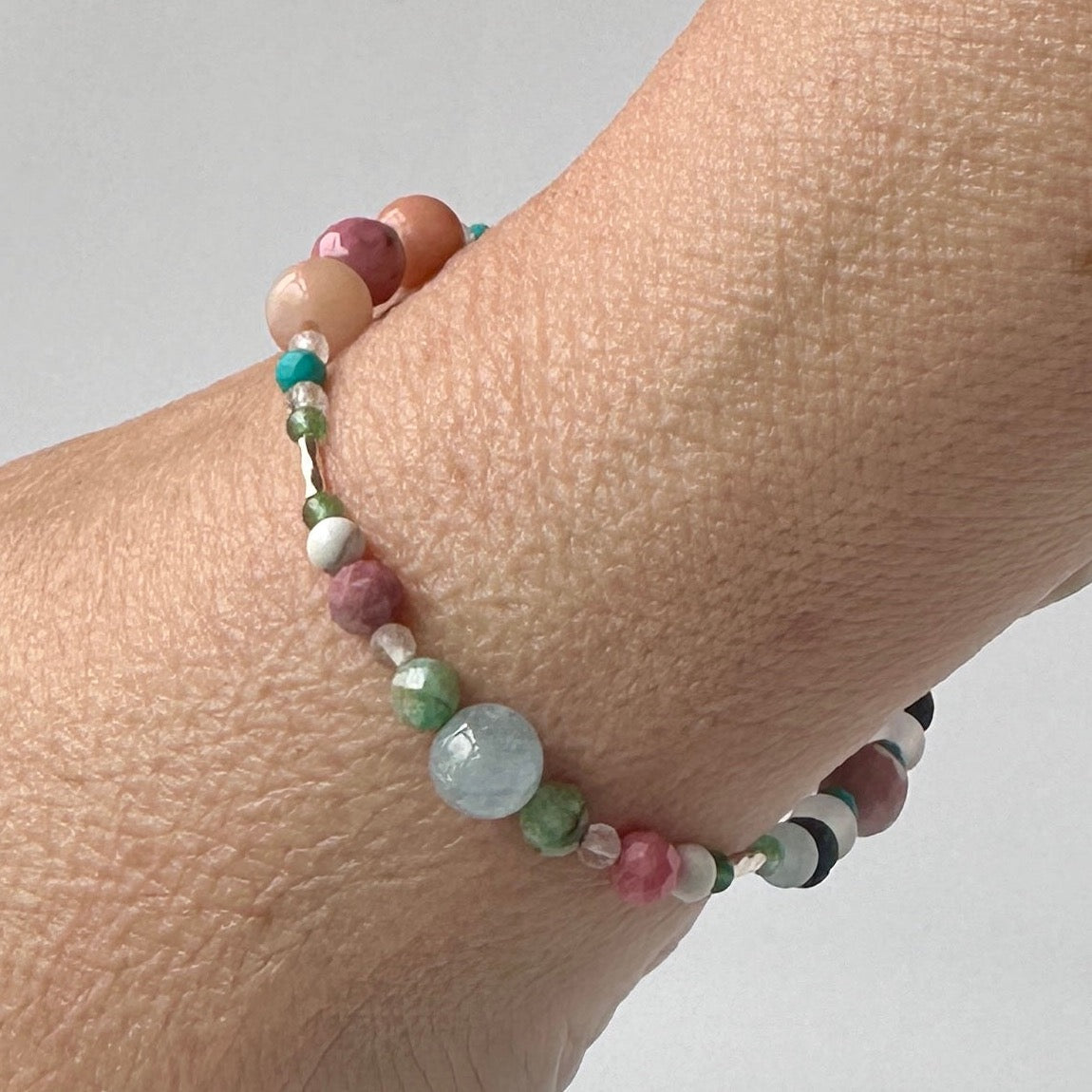 Cancer Birthstone Healing Crystal bracelet for Calm & Anxiety Relief on wrist showing Chrysocolla, Rhodonite, Turquoise, Aquamarine, Aventurine and Howlite