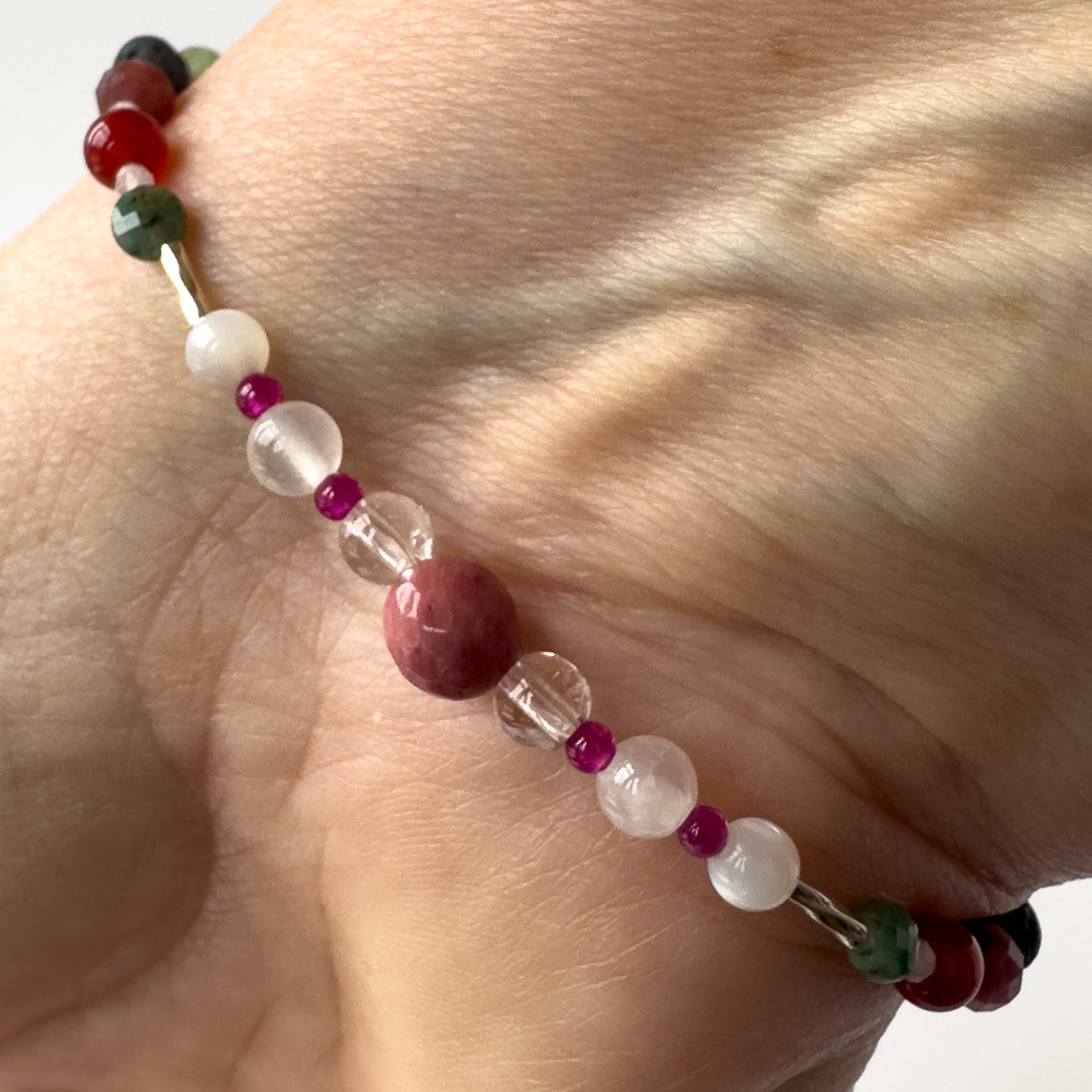 Cancer Birthstone Healing Crystal bracelet for Grief & Loss support on wrist showing Moonstone, Ruby, Rhodonite, Rose Quartz, Selenite and Clear Quartz