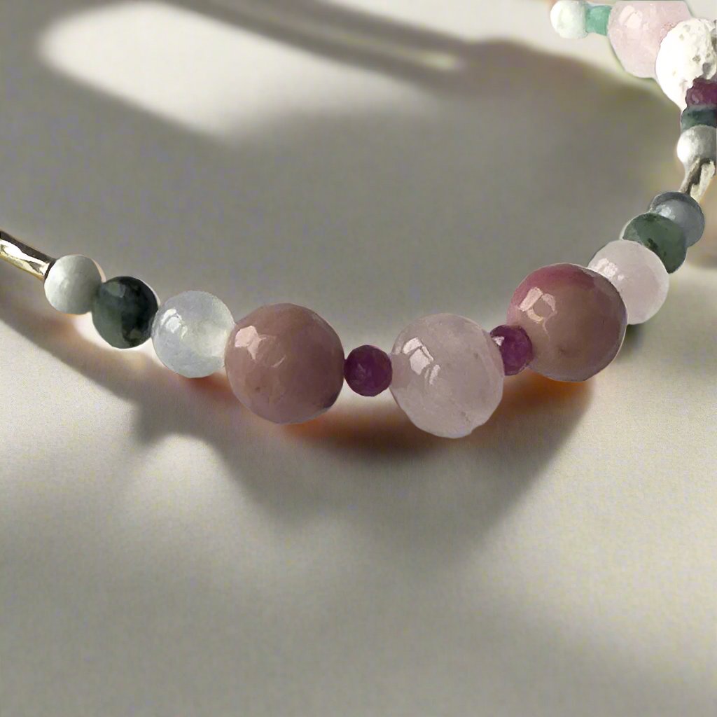 Cancer birthstone Healing Crystal bracelet for Love and Compassion showing Rose Quartz, Emerald, Howlite, Rhodonite Ruby, and Selenite