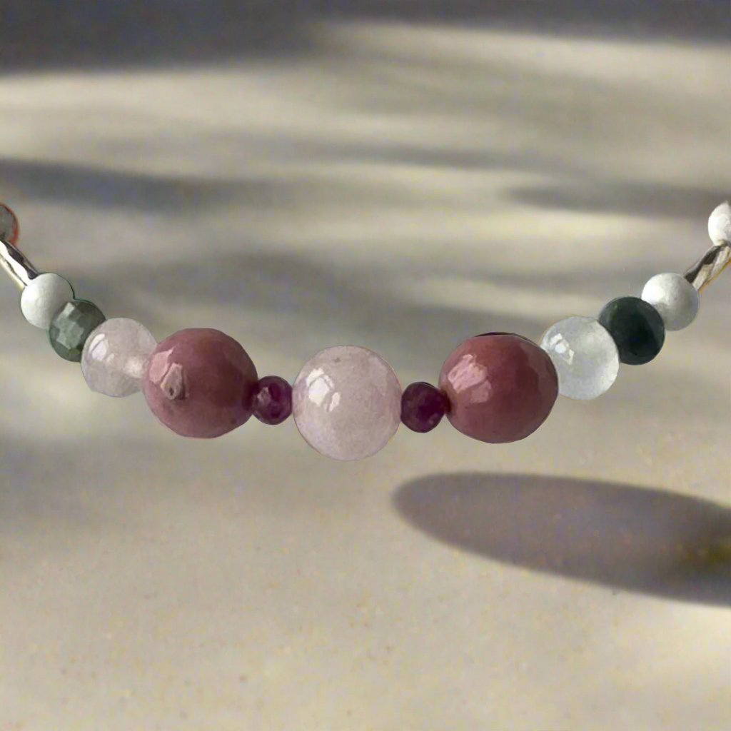 Cancer birthstone Healing Crystal bracelet for Love and Compassion showing Rose Quartz, Emerald, Howlite, Rhodonite, Ruby and Selenite