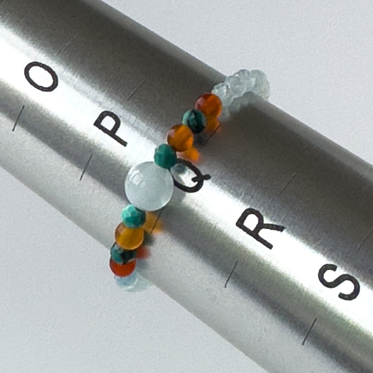 Cancer Birthstone Healing Crystal ring for Strength and Courage on mandrel showing size of Q