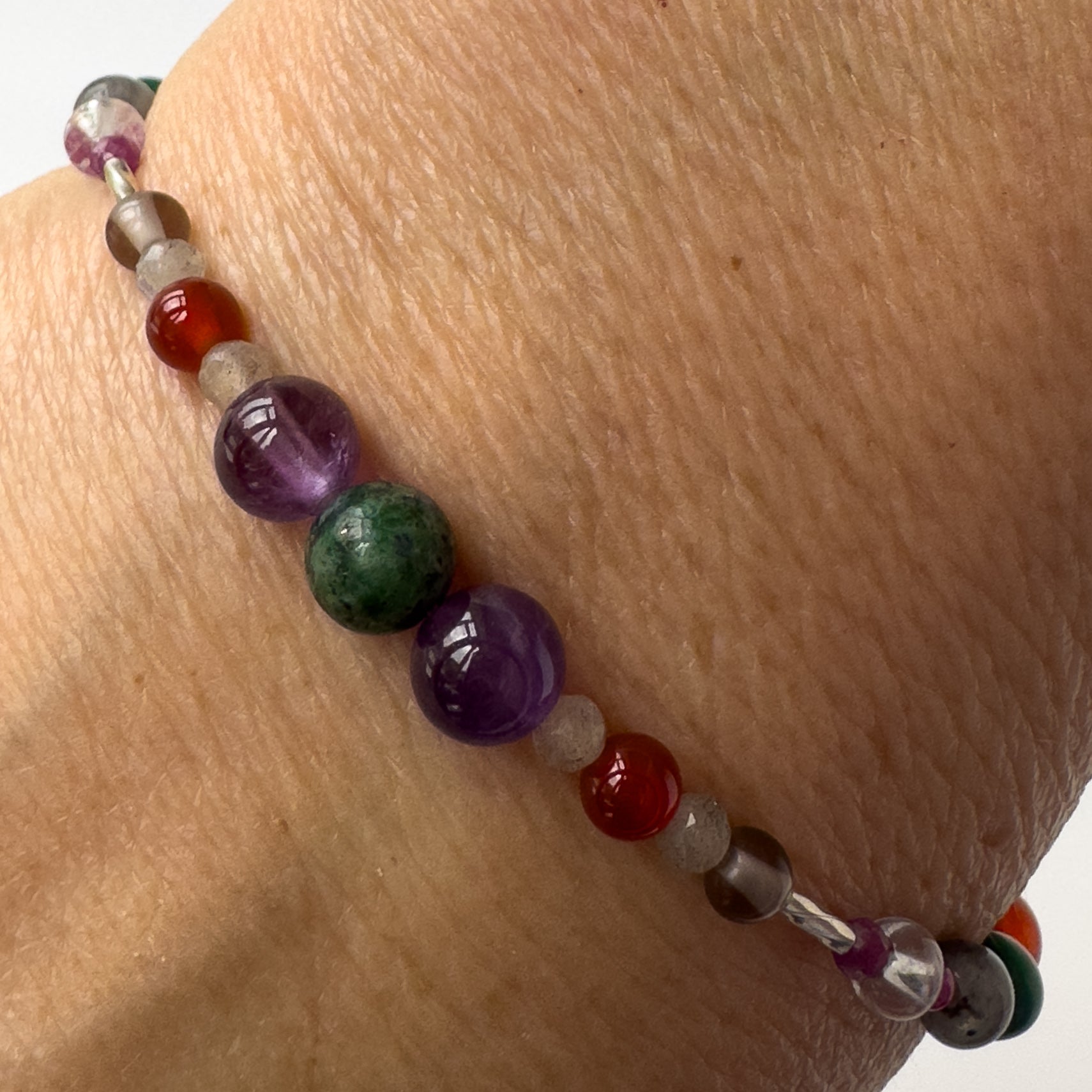 Capricorn Crystal Healing bracelet for Grief & Loss on wrist showing Smoky Quartz, Labradorite, Amethyst, Carnelian and Azurite