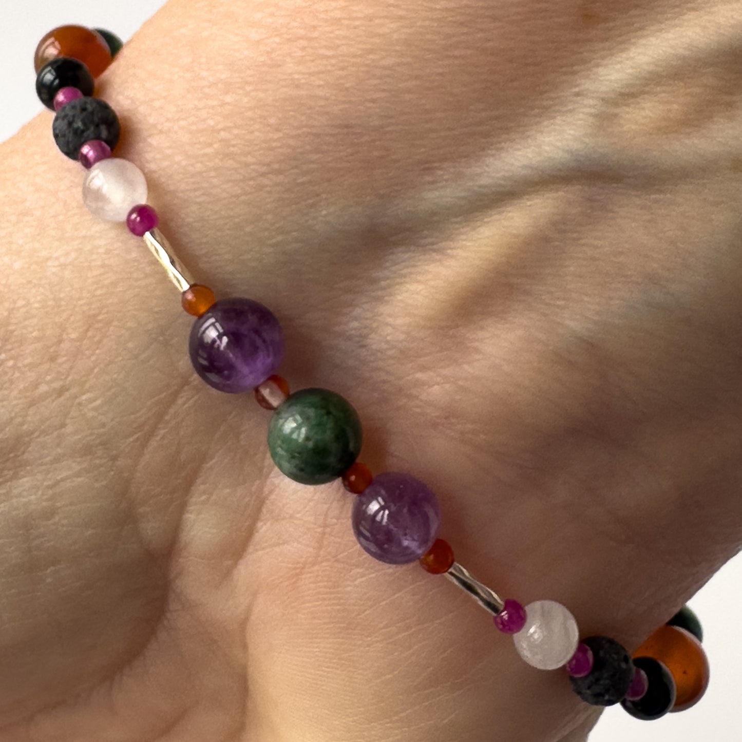 Capricorn birthstone Healing Crystal bracelet for Grief & Loss support on wrist showing, Amethyst, Carnelian and Azurite