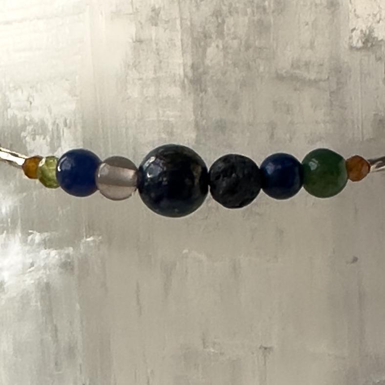 Capricorn birthstone Healing Crystal bracelet for Calm & Stress relief showing Garnet, Moss Agate, Peridot, Smoky Quartz, Azurite, Sodalite and Lava Stone