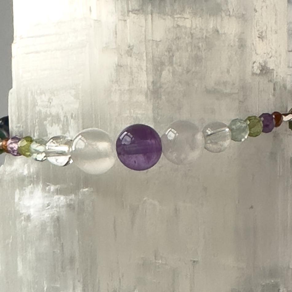 Capricorn birthstone Healing Crystal bracelet for Calm & Stress relief showing Garnet, Peridot, Amethyst, Fluorite, Selenite and Clear Quartz