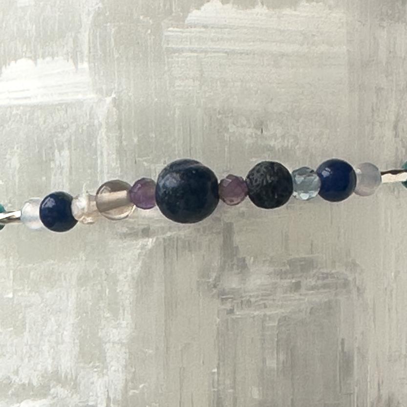 Capricorn Birthstone Healing Crystal bracelet for Calm & Anxiety Relief showing Blue Lace Agate, Smoky Quartz, Amethyst, Fluorite, Azurite, Sodalite and Lava Stone