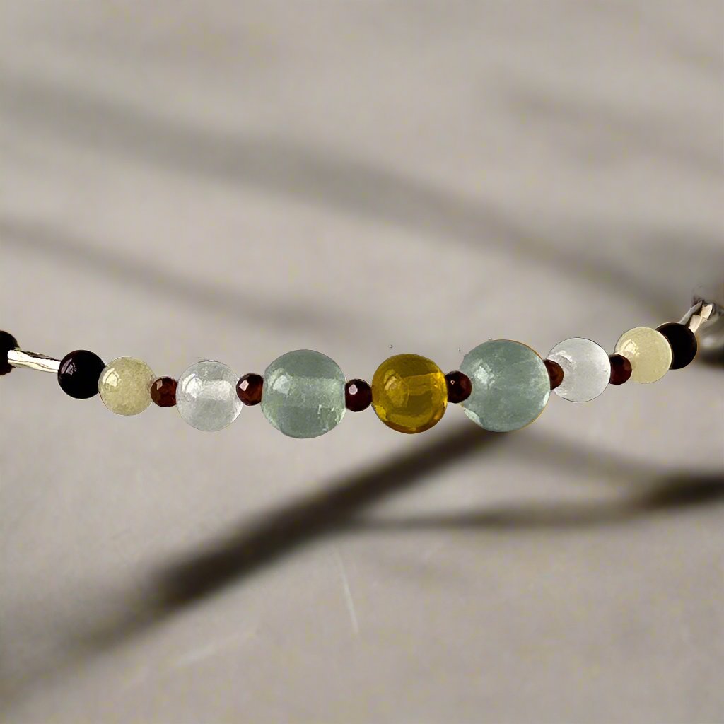 Capricorn birthstone Healing Crystal bracelet for Confidence and Self-esteem showing Garnet, Mahogany Obsidian, Amber, Fluorite, Aragonite and Selenite