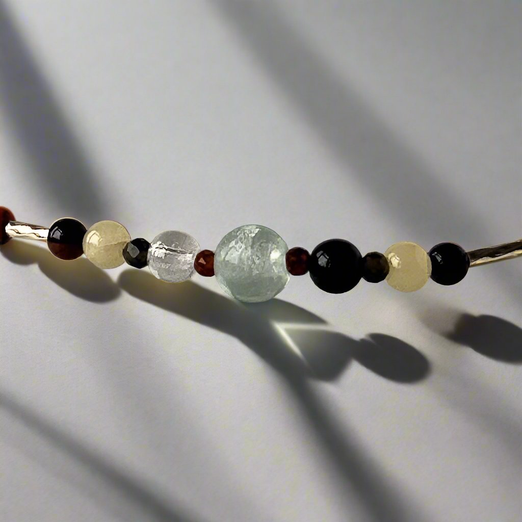 Capricorn Birthstone Healing Crystal bracelet for Confidence showing Garnet, Mahogany Obsidian, Onyx, Fluorite, Aragonite and Clear Quartz