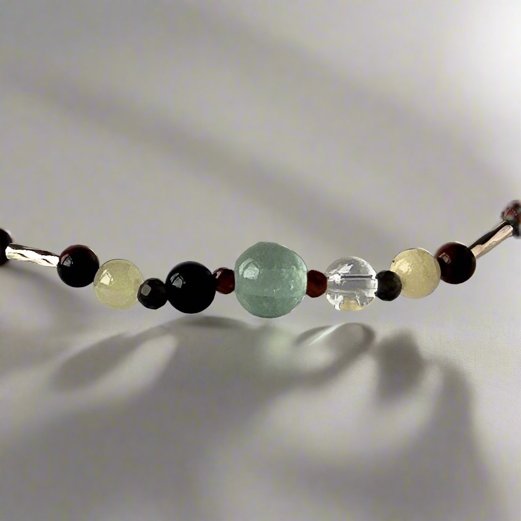 Capricorn Birthstone Healing Crystal bracelet for Confidence and Self-esteem showing Garnet, Obsidian, Mahogany Obsidian, Onyx, Fluorite, Aragonite and Clear Quartz