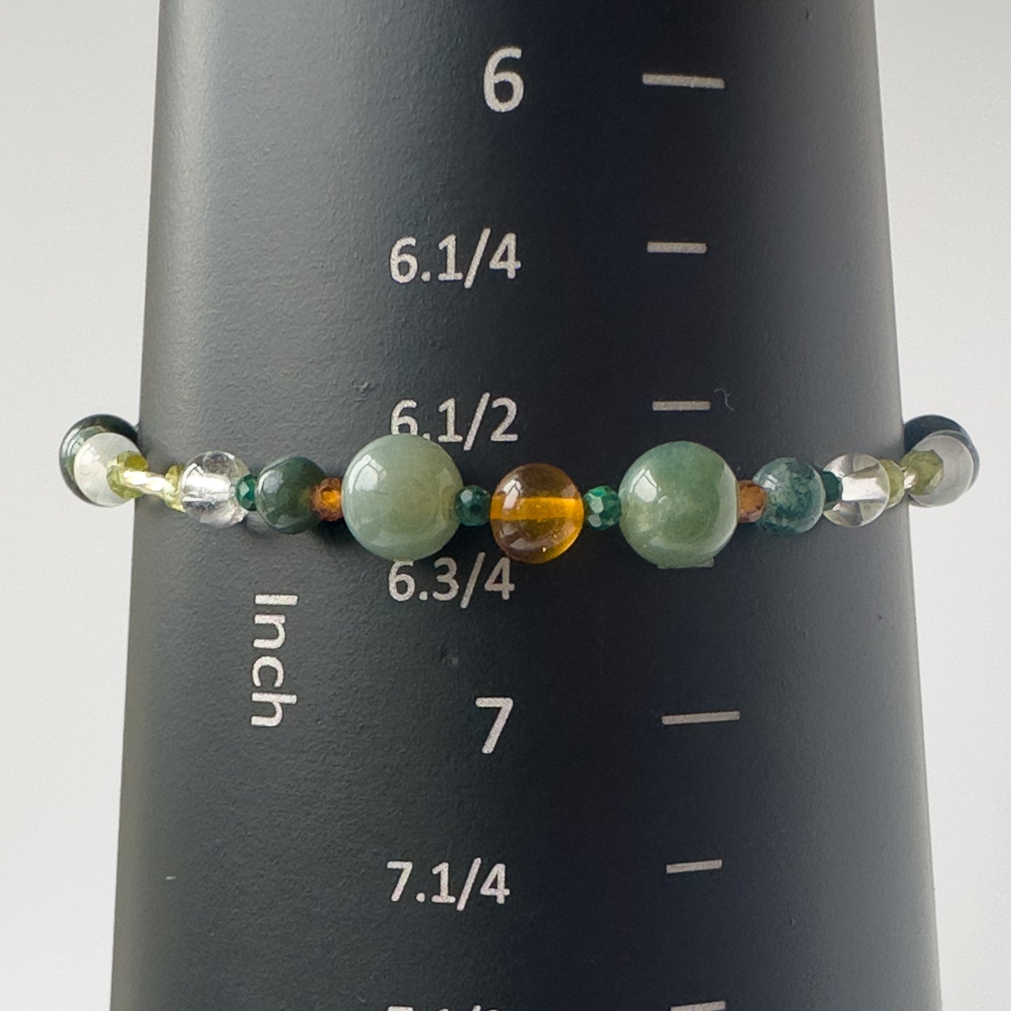 Capricorn Birthstone Healing Crystal bracelet for Love and Compassion on mandrel showing size of 6.5-6.75 inches
