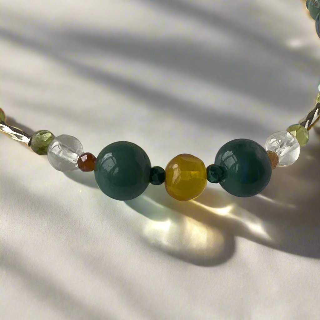 Capricorn Birthstone Healing Crystal bracelet for Love and Compassion showing Peridot, Amber, Moss Agate, Garnet, Malachite and Clear Quartz