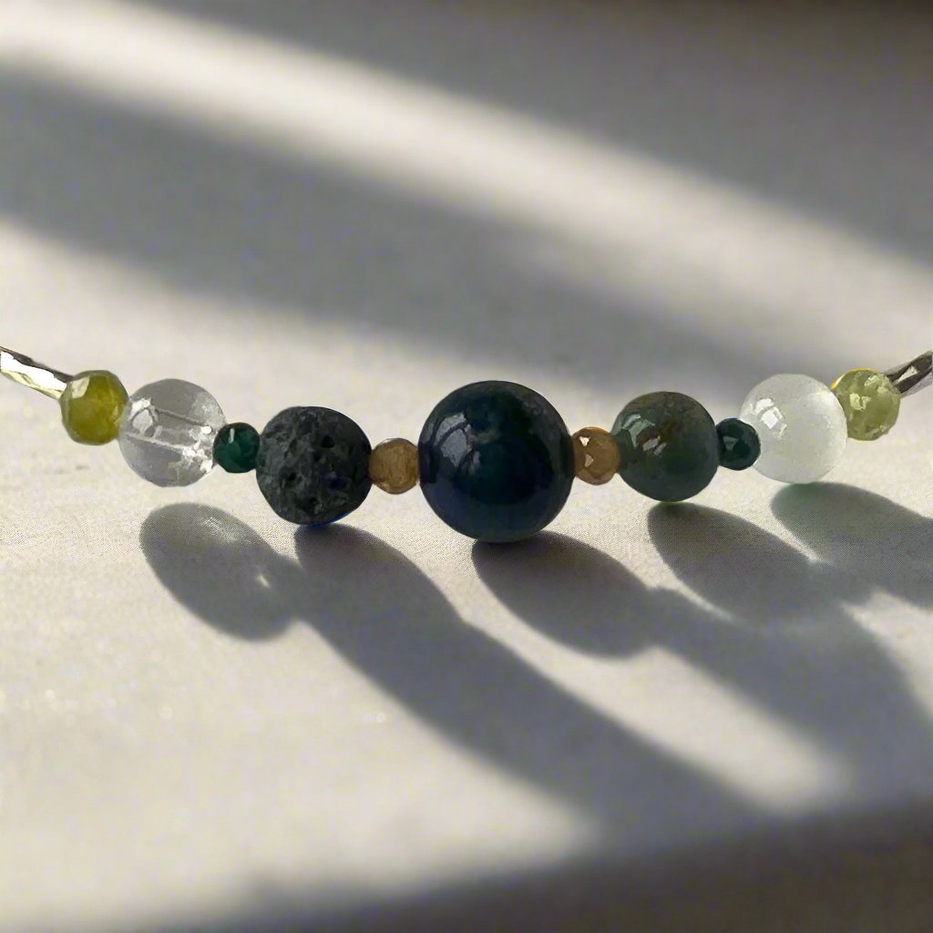 Capricorn Birthstone Healing Crystal bracelet for Love and Compassion showing Peridot, Moss Agate, Azurite, Garnet, Malachite, Lava Stone, Selenite and Clear Quartz