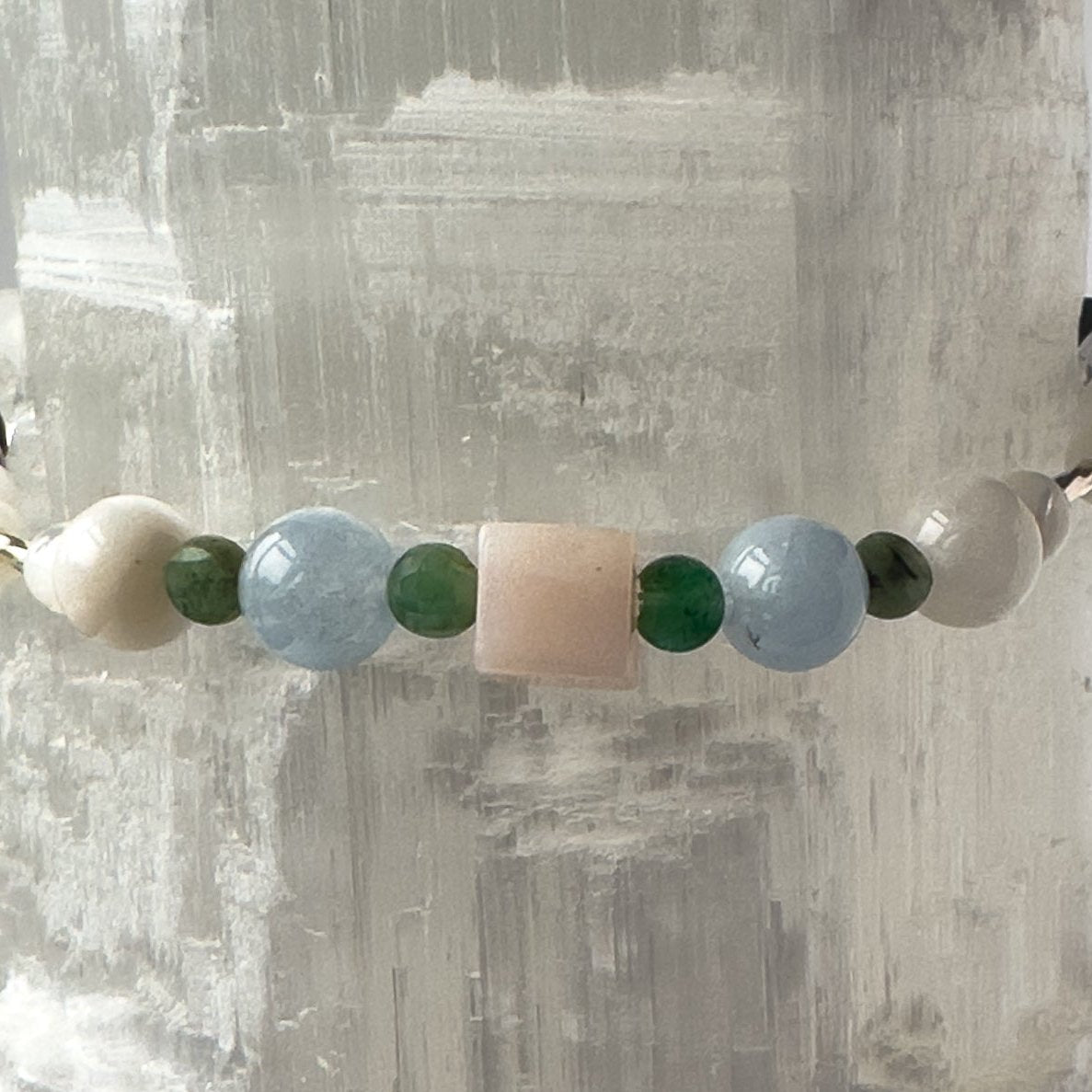 Close-up of Cancer Birthstone Healing Crystal bracelet for Calm & Stress relief showing Moonstone, Emerald, Aquamarine and Pink Opal