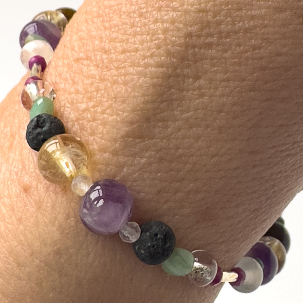 Gemini birthstone Healing Crystal bracelet for Grief & Loss support on wrist showing Emerald, Citrine, Amethyst, Clear Quartz and Lava Stone