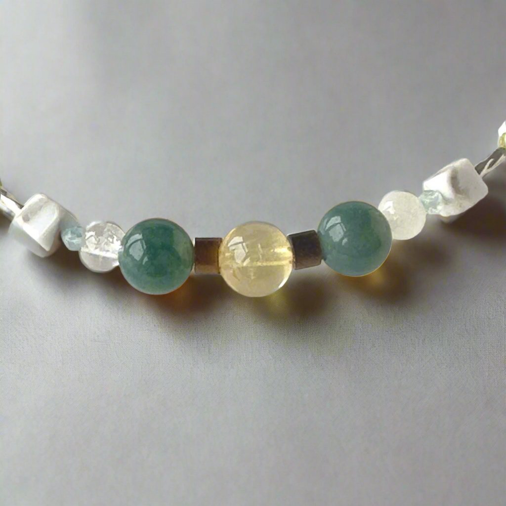 Gemini Birthstone Healing Crystal bracelet for Love and Compassion showing Citrine, Moss Agate, Howlite, Tiger’s Eye, Topaz, Selenite and Clear Quartz