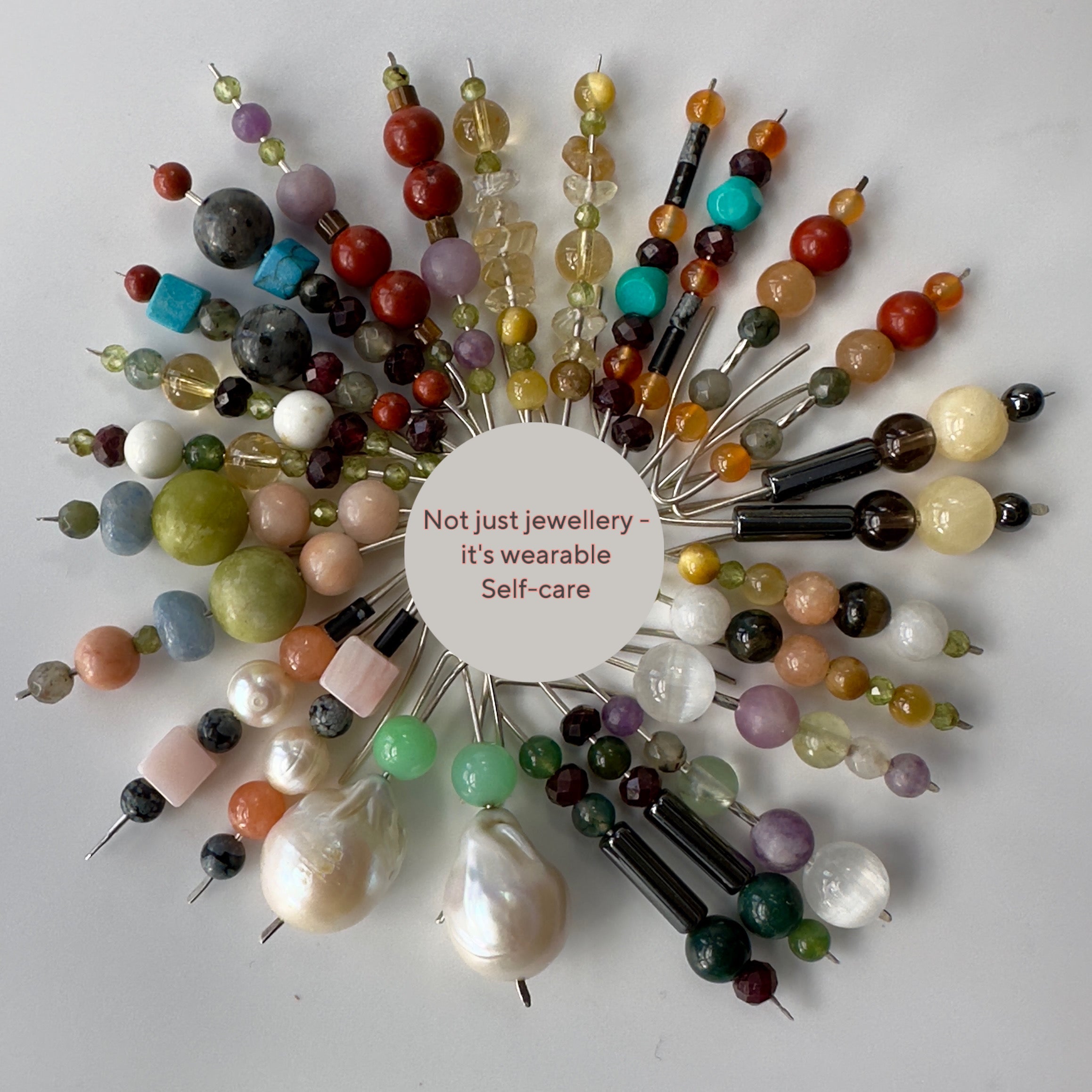 Selection of handmade sterling silver and healing crystal earrings with the phrase Not just jewellery - it’s wearable self-care