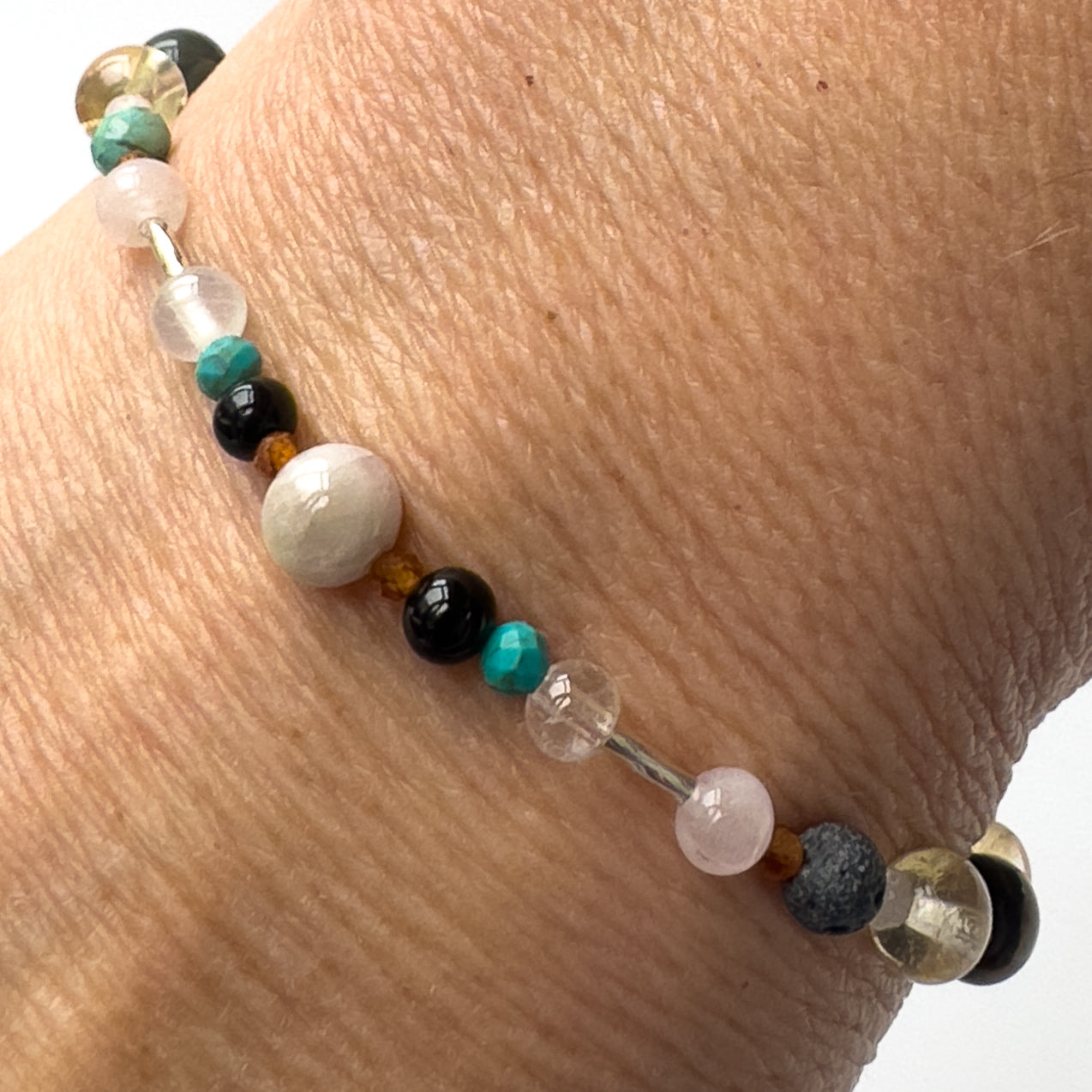 Leo Healing Crystal bracelet for Anxiety on wrist showing Onyx, Rose Quartz, Garnet, Kunzite, Turquoise, Selenite and Clear Quartz