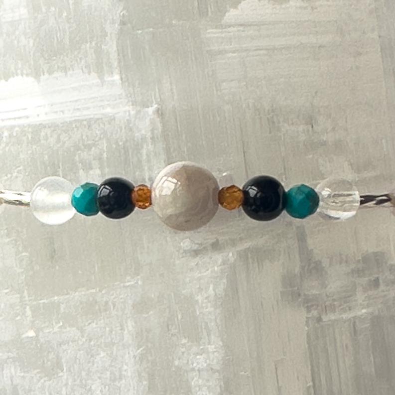 Leo Birthstone Healing Crystal bracelet for Calm & Anxiety Relief showing Onyx, Garnet, Kunzite,Turquoise, Selenite and Clear Quartz