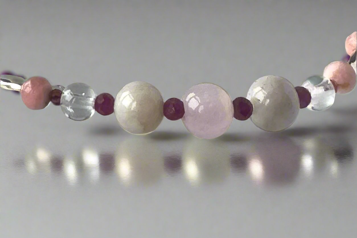 Leo Birthstone Healing Crystal bracelet for Love and Compassion showing Rose Quartz, Garnet, Kunzite, Rhodochrosite, Ruby and Clear Quartz