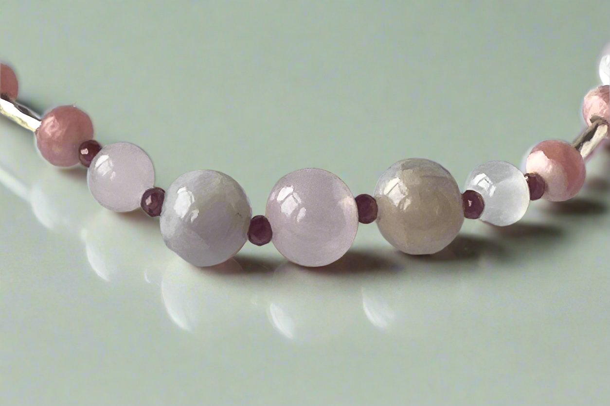Leo Birthstone Healing Crystal bracelet for Love and Compassion showing Rose Quartz, Garnet, Kunzite, Rhodochrosite, Ruby and Selenite