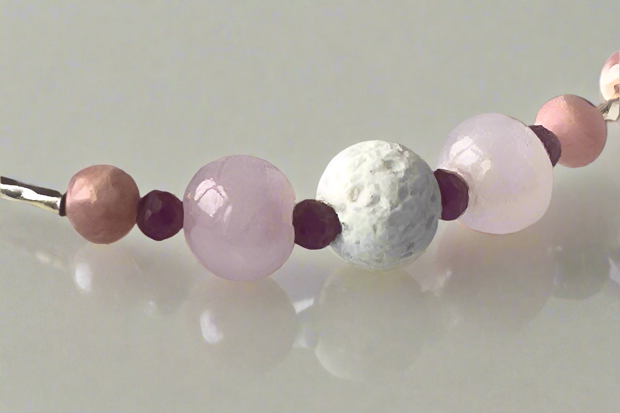 Leo Birthstone Healing Crystal bracelet for Love and Compassion showing Rose Quartz, Garnet, Rhodochrosite, Ruby and Lava Stone