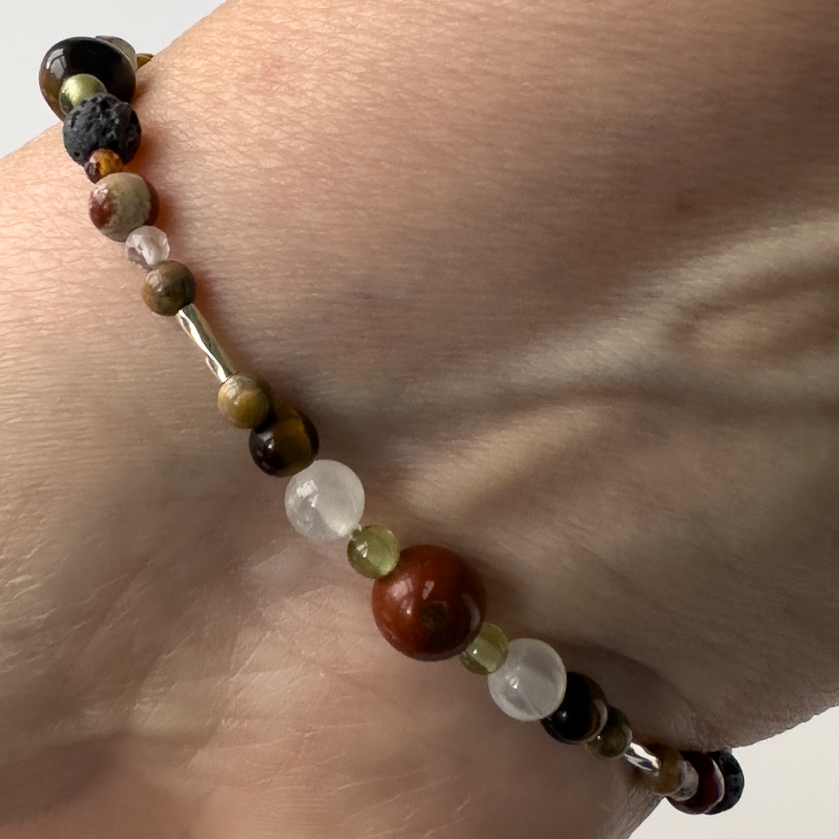 Leo Birthstone Healing Crystal bracelet for Calm & Stress relief on wrist showing Yellow Tiger’s Eye, Peridot, Jasper and Selenite