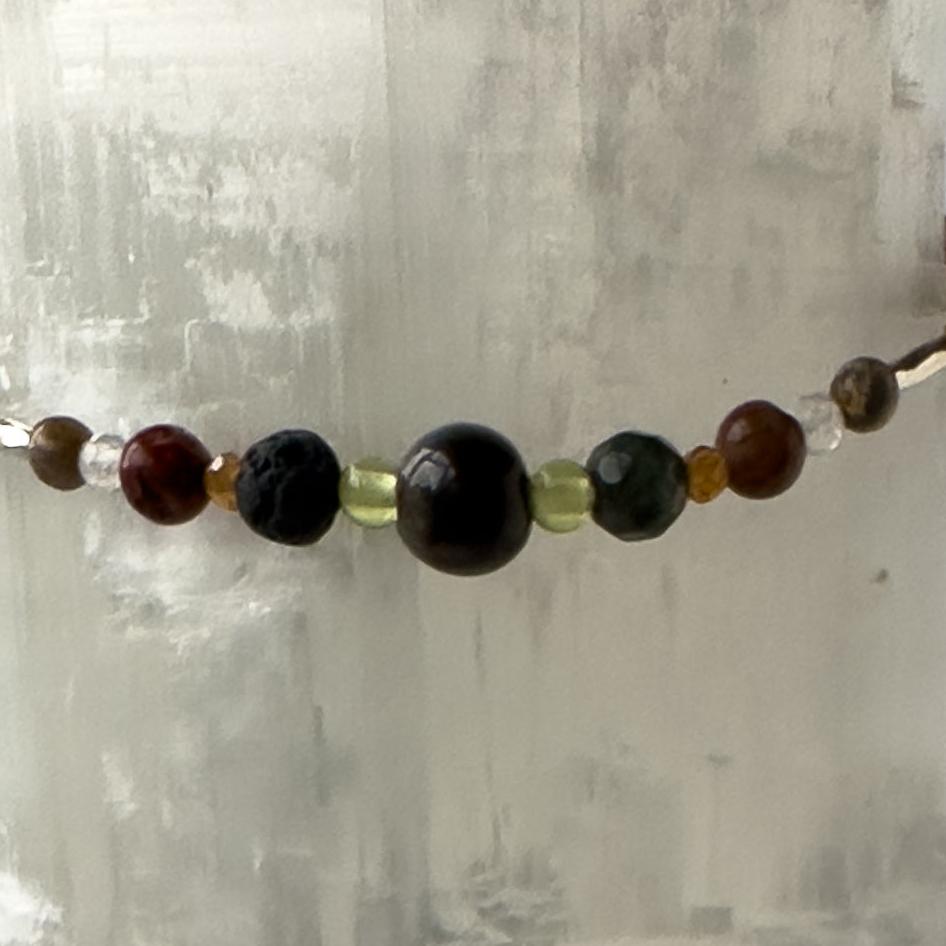 Leo Birthstone Healing Crystal bracelet for Calm & Stress relief showing Blue Tiger’s Eye, Peridot, Jasper, Garnet, Bloodstone, Clear Quartz and Lava Stone