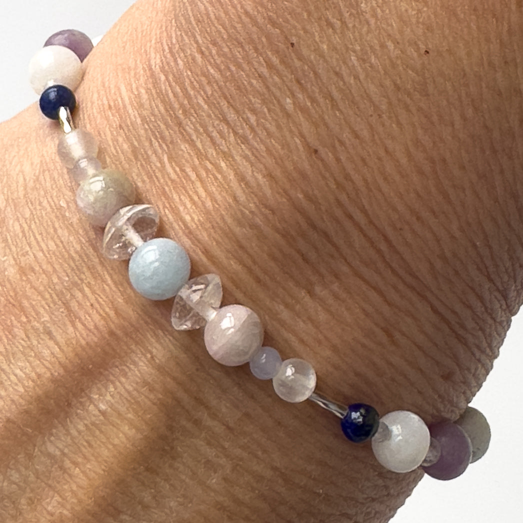 Libra Healing Crystal bracelet for Anxiety on a wrist showing Rose Quartz, Lapis Lazuli, Aquamarine, Blue Lace Agate, Lepidolite, Kunzite, Moonstone, and Clear Quartz