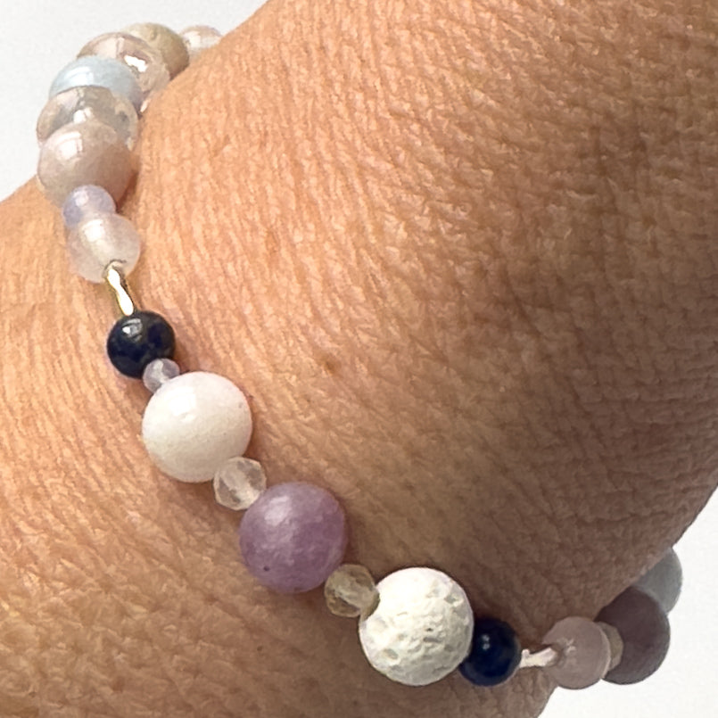 Libra Birthstone Healing Crystal bracelet for Calm & Anxiety Relief on wrist showing Rose Quartz, Lapis Lazuli, Citrine, Blue Lace Agate, Lepidolite, Kunzite, Moonstone and Lava Stone