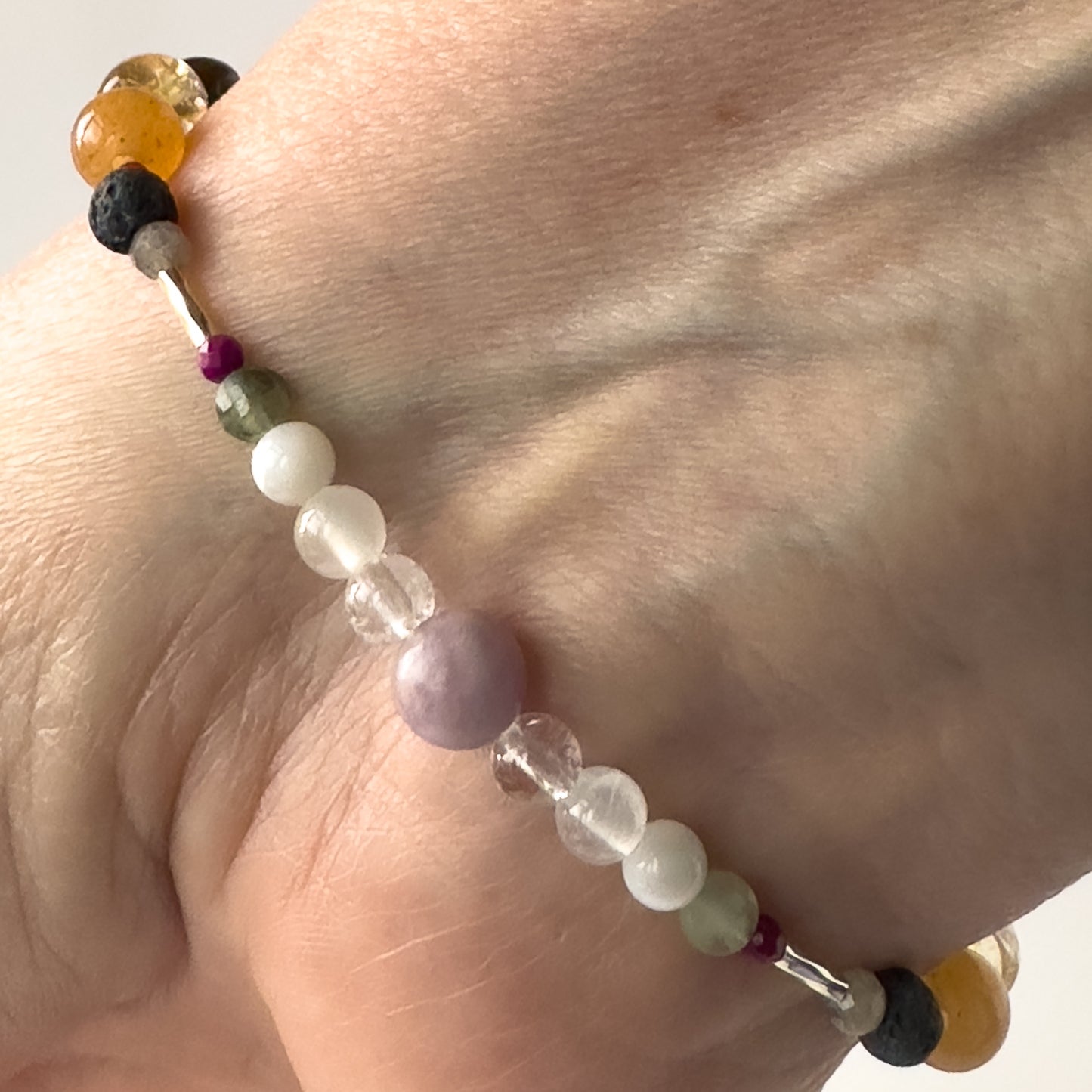 Libra Birthstone Healing Crystal bracelet for Grief & Loss support on wrist showing Sugilite, Labradorite, Lepidolite, Moonstone, Selenite and Clear Quartz