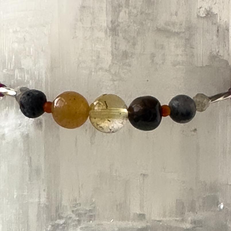 Libra Birthstone healing Crystal bracelet for Grief & Loss support showing Sugilite, Blue Tiger’s Eye, Citrine, Labradorite, Carnelian and Lava Stone