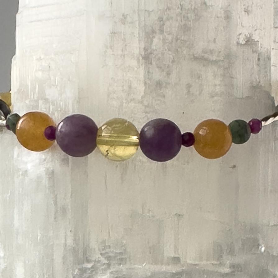 Libra Birthstone Healing Crystal bracelet for Grief & Loss support showing Sugilite, Citrine, Lepidolite, Carnelian and Emerald
