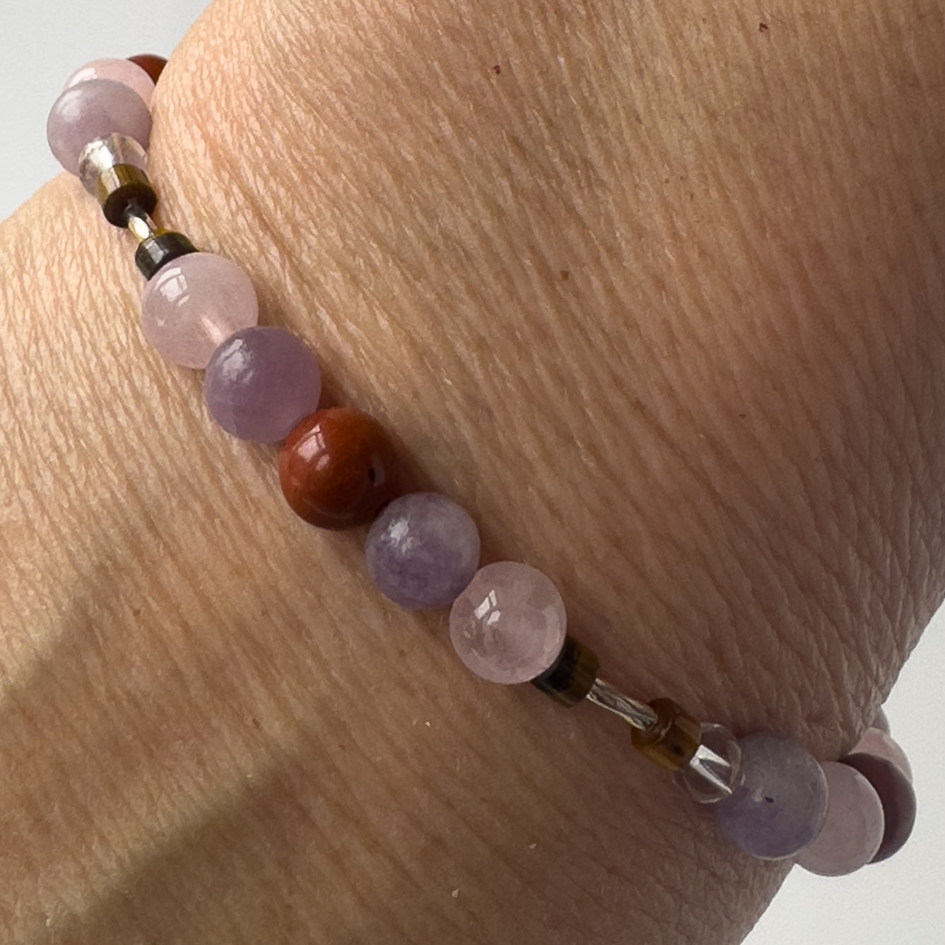 Libra Healing Crystal bracelet for Love on wrist showing Rose Quartz, Red Jasper, Lepidolite and Tiger’s Eye