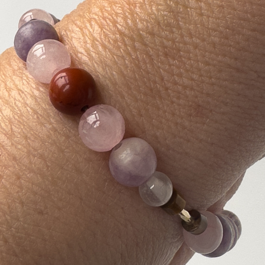 Libra Birthstone Healing Crystal bracelet for Love and Compassion on wrist showing Rose Quartz, Red Jasper, Lepidolite, Tiger’s Eye and Selenite