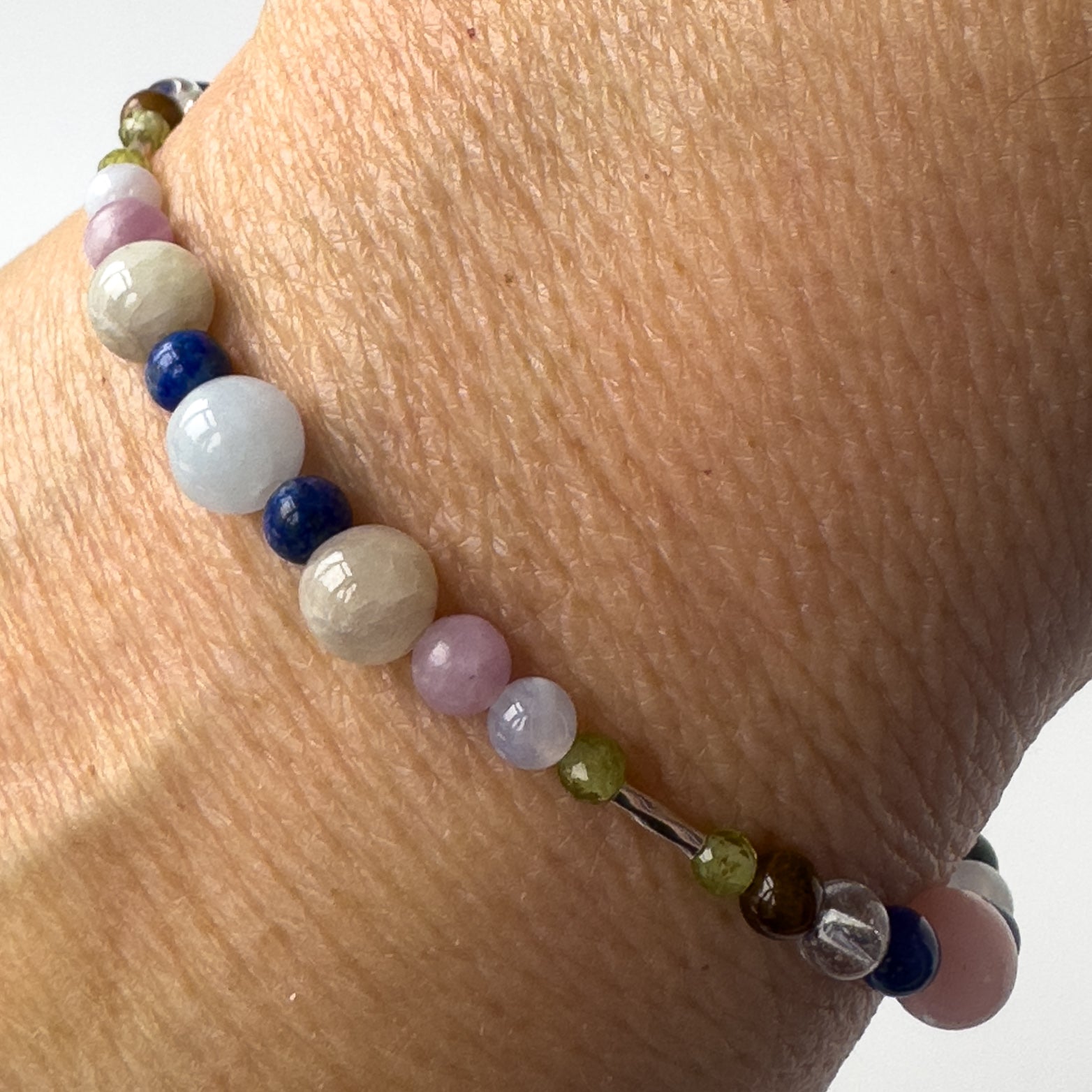 Libra Healing Crystal bracelet for Stress on wrist showing Peridot, Lapis Lazuli, Aquamarine, Blue Lace Agate, Lepidolite and Kunzite