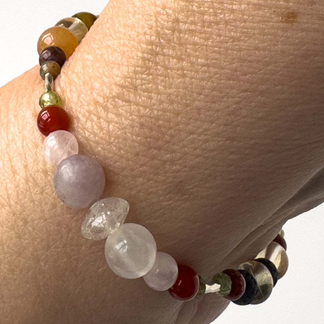 Libra Birthstone Healing Crystal bracelet for Determination & Willpower on wrist showing Rose Quartz, Lepidolite, Carnelian, Selenite and Clear Quartz