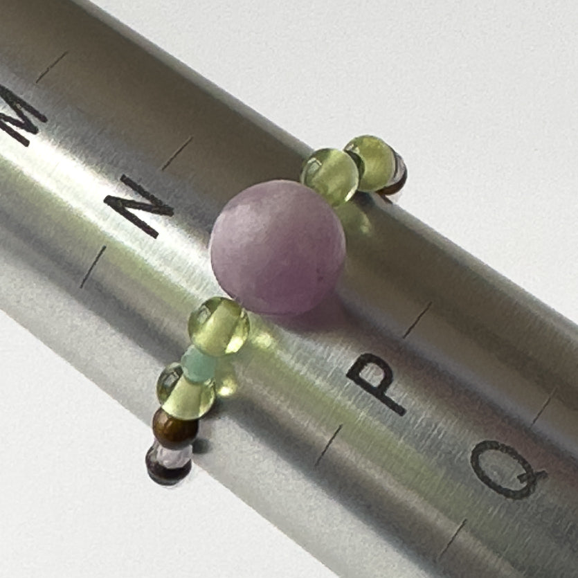 Love And Compassion birthstone Healing Crystal ring for Pisces or Libra on mandrel showing size of O