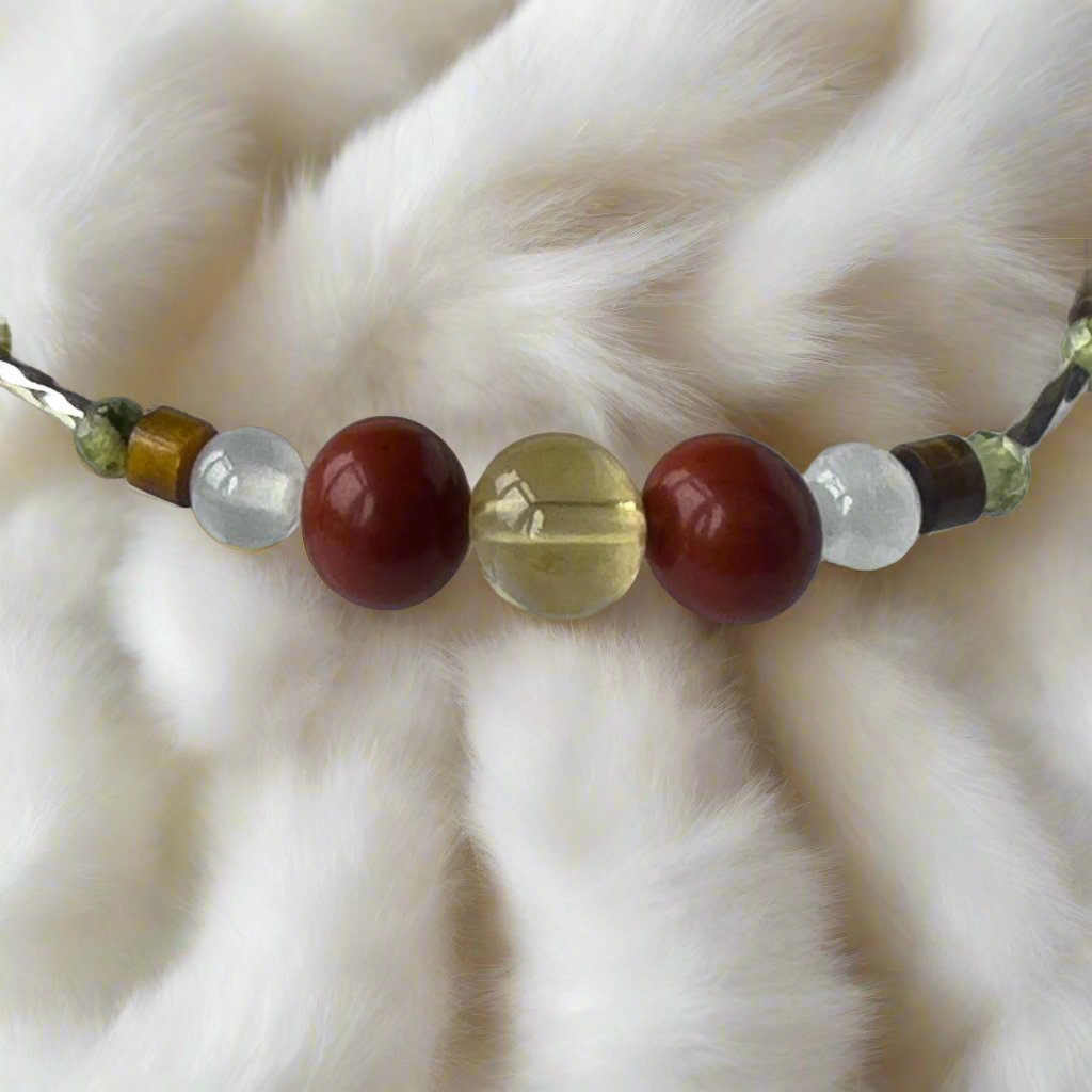 Pisces Birthstone Healing Crystal bracelet for Love and Compassion showing Citrine, Peridot, Red Jasper, Tiger’s Eye and Selenite