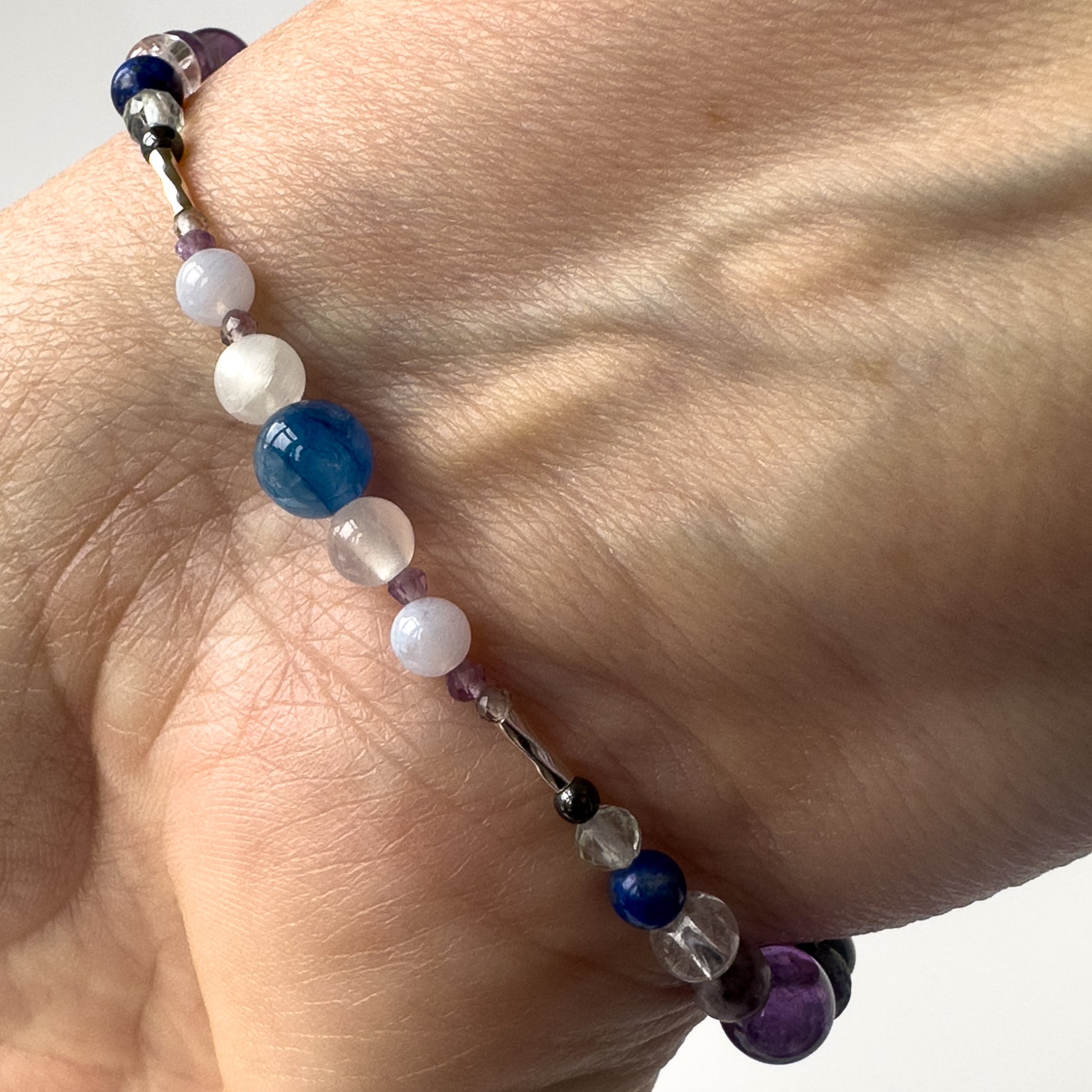 Pisces Birthstone Healing Crystal bracelet for Calm & Stress on wrist showing Amethyst, Blue Lace Agate, Moonstone, Kyanite and Selenite