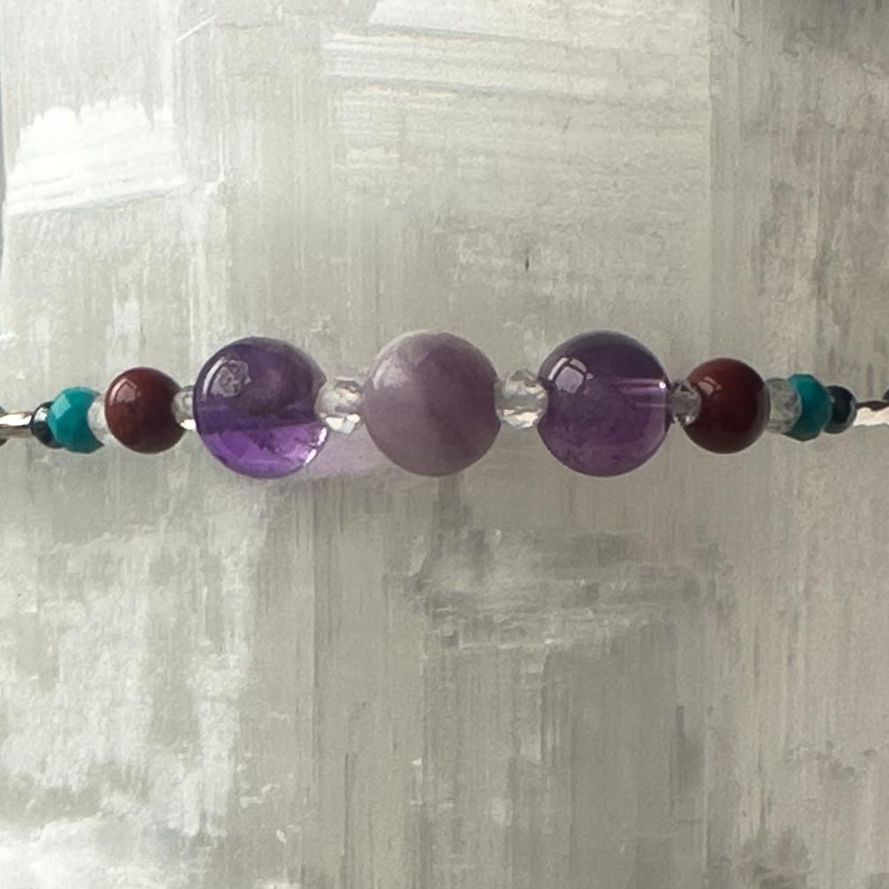 Pisces Birthstone Healing Crystal bracelet for Determination & Willpower showing Amethyst, Lepidolite, Hematite, Turquoise, Red Jasper and Rainbow Fluorite