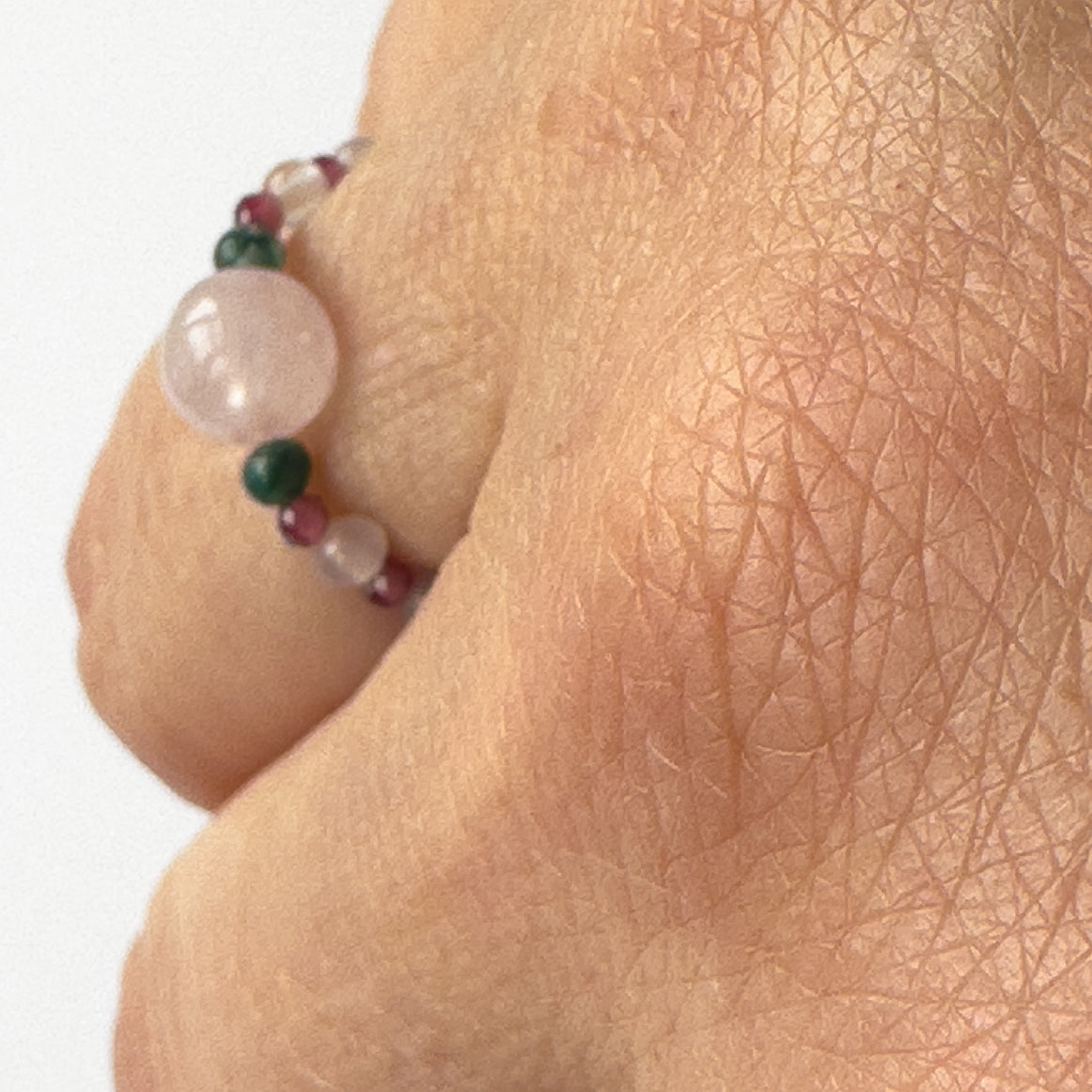 Profile view of Aquarius Birthstone Healing Crystal ring for Love and Compassion on finger