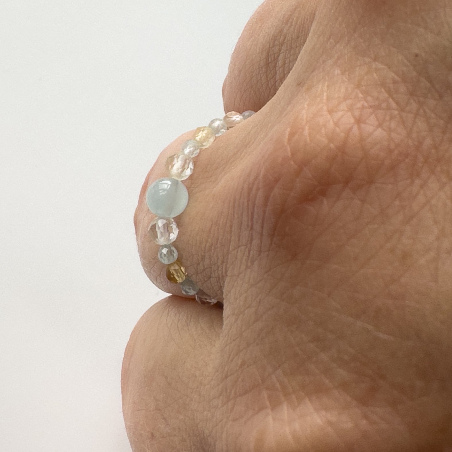 Profile view of Courage Birthstone Healing Crystal ring for Gemini, Aries, Libra or Scorpio on finger