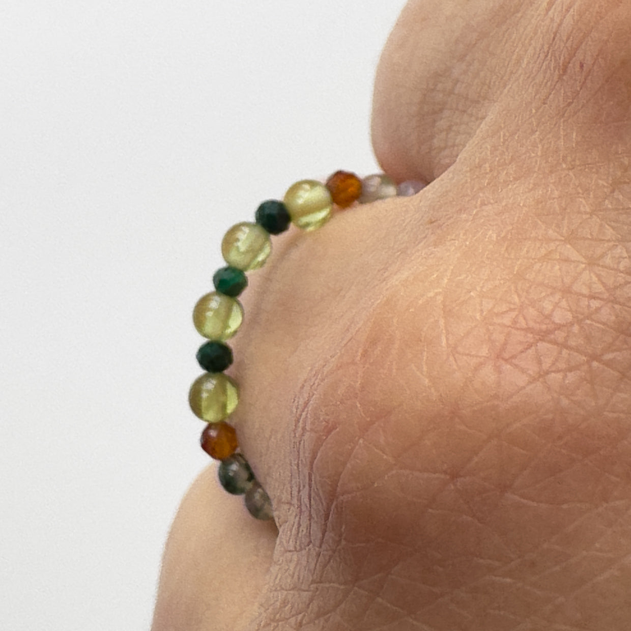 Profile view of Love And Compassion birthstone Healing Crystal ring for Capricorn or Scorpio on finger