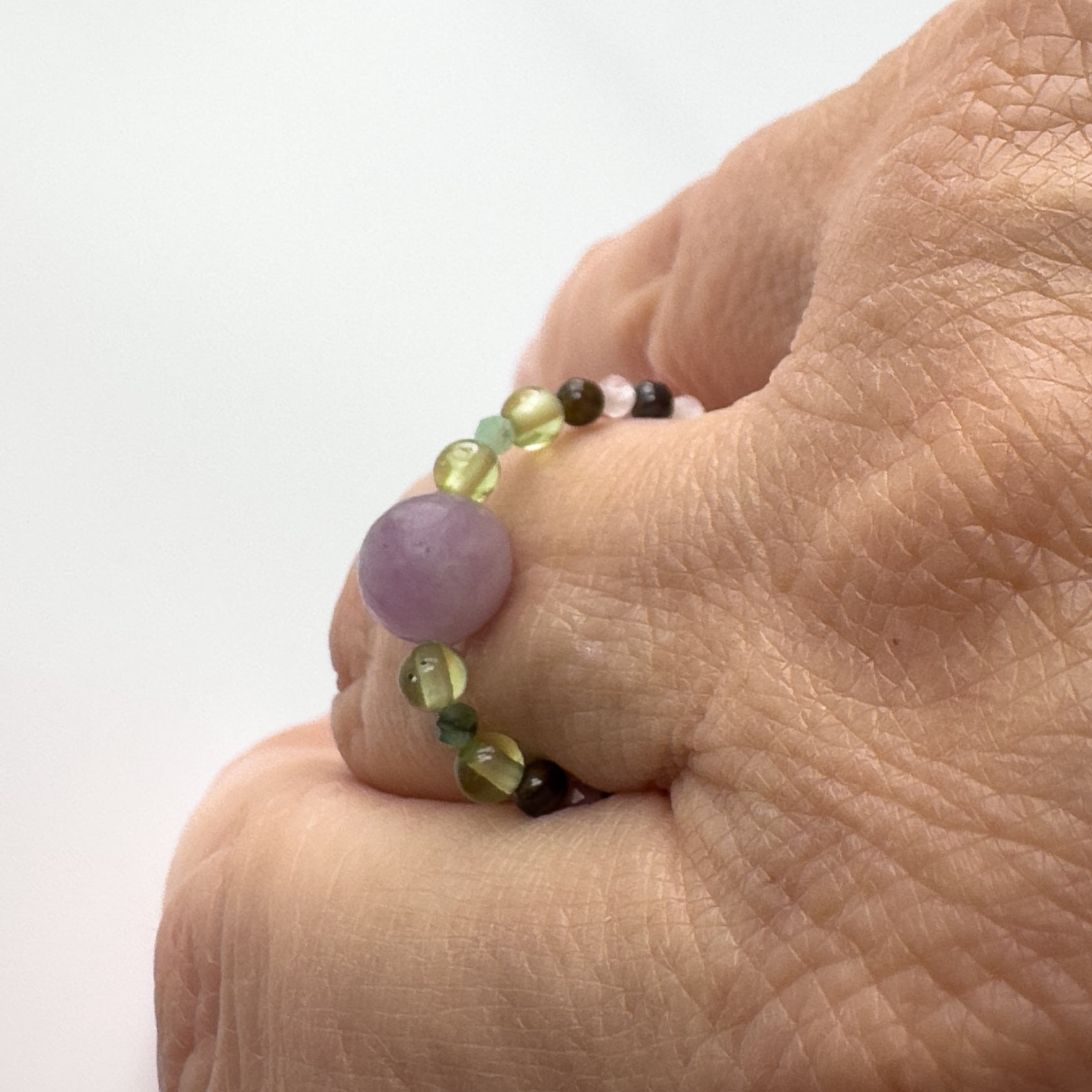 Profile view of Love And Compassion Healing Crystal ring for Pisces or Libra on finger