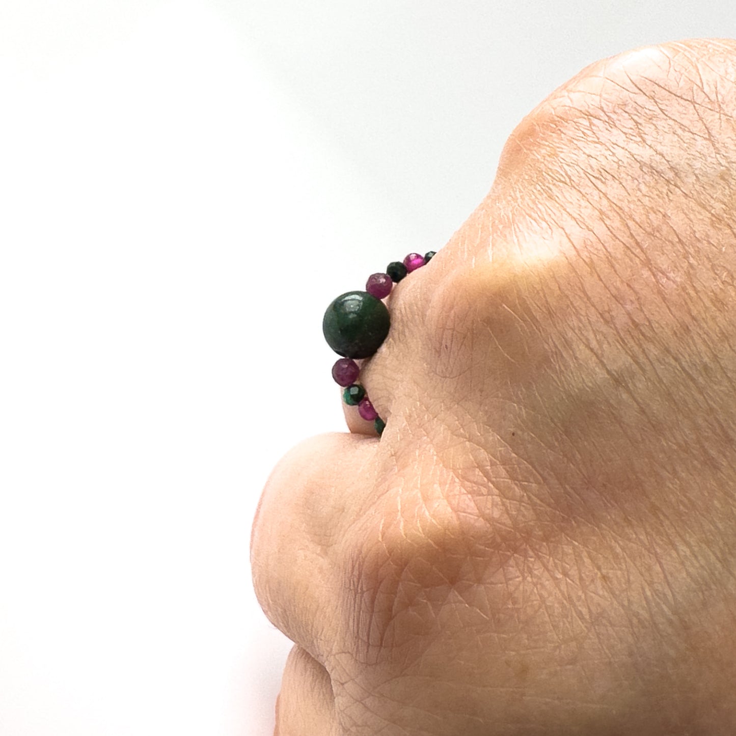 Profile view of Love And Compassion Healing Crystal ring for Sagittarius or Capricorn on finger